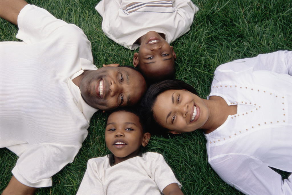 Portrait of a Family Lying on Grass
