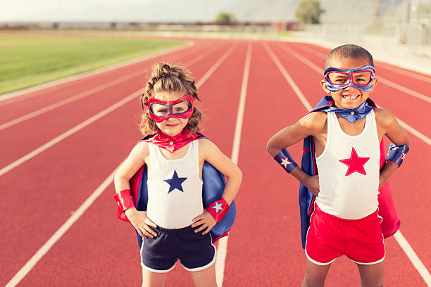 Two Kids on the Track in Superhero Costume